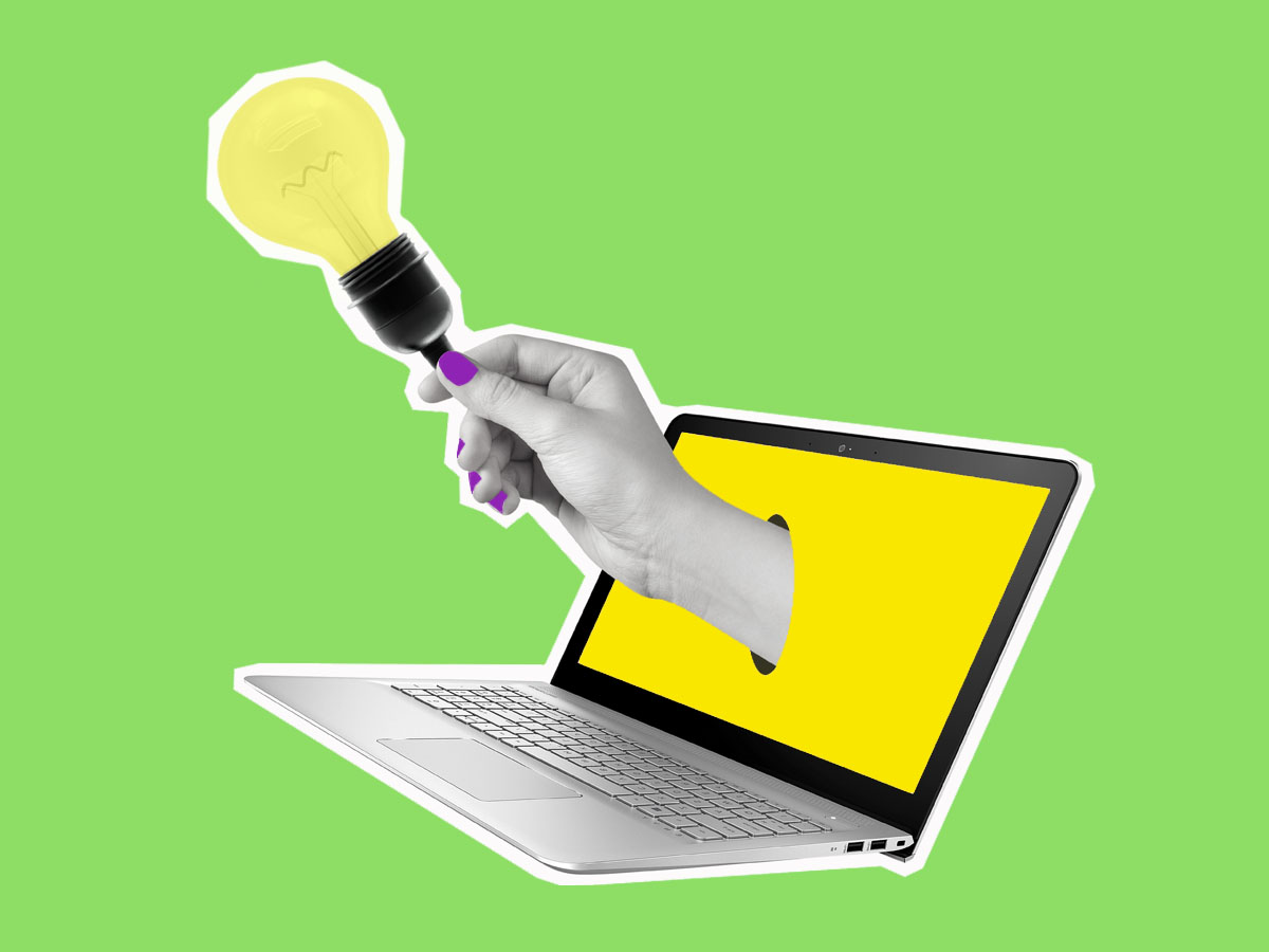 Hand with lightbulb reaching out of a laptop computer