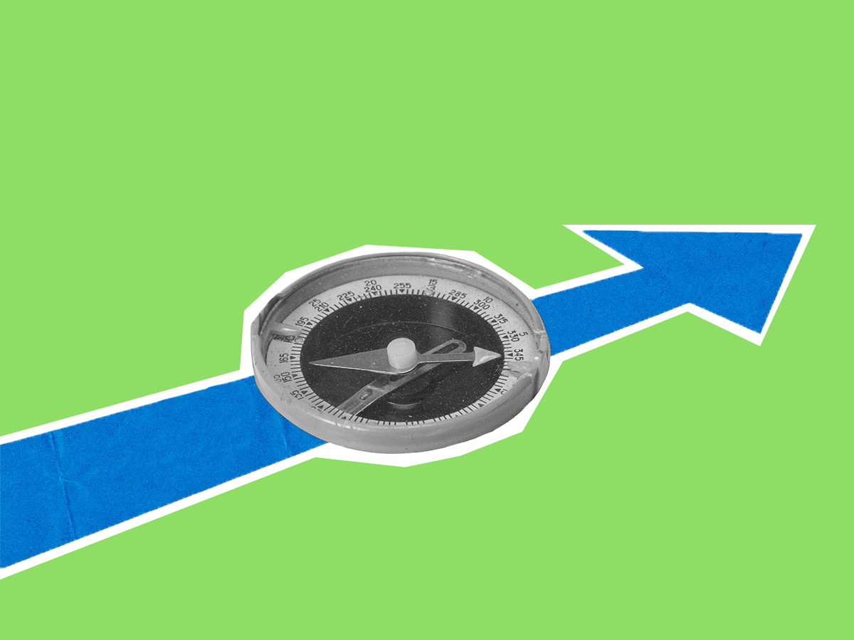 Compass on an arrow indicating forward navigation