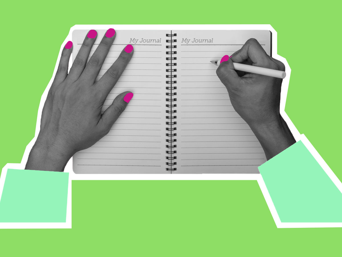 Women's hands writing in a journal